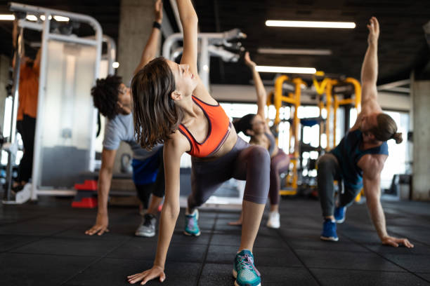 istock Healthy young athletes friends doing exercises at gym. 1204163413