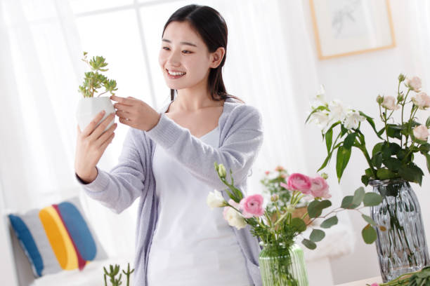 istock Young women carry pots 1204163643