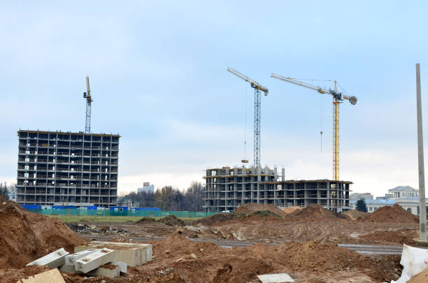 istock Tower cranes constructing a new residential building at a construction site 1204163755