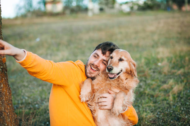 istock Guy and his dog, golden retriever, nature 1204163852