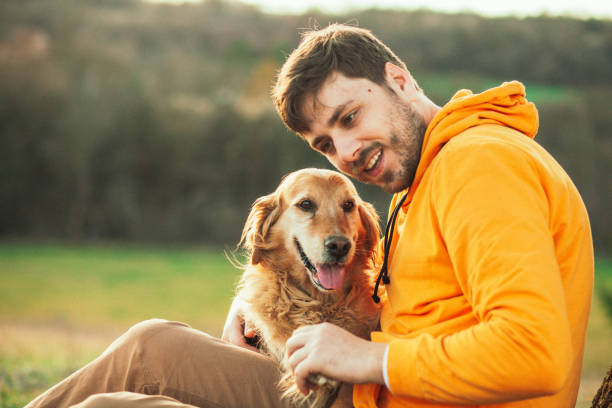 istock Guy and his dog, golden retriever, nature 1204163896