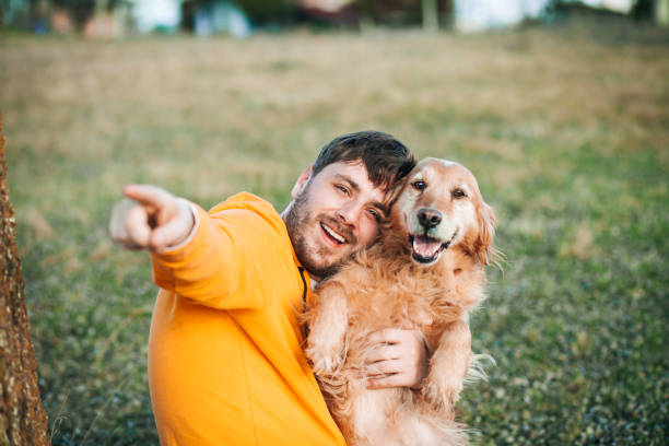 istock Guy and his dog, golden retriever, nature 1204163967