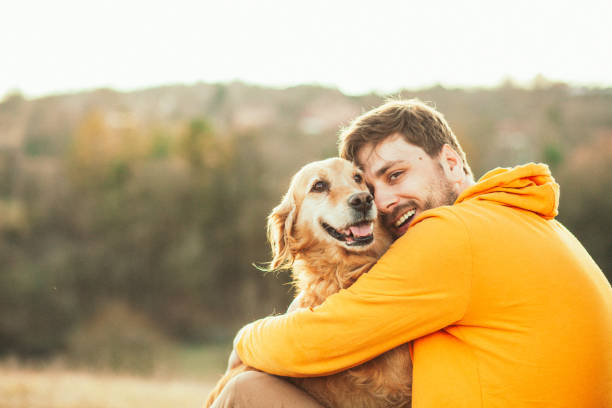istock Guy and his dog, golden retriever, nature 1204164150