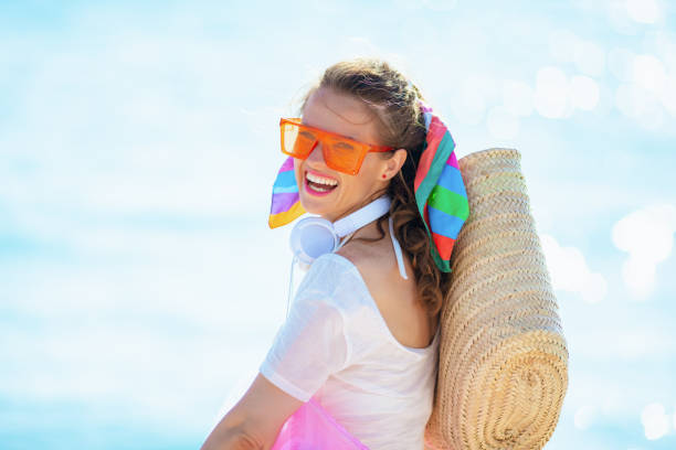 istock smiling modern woman on ocean coast 1204164174