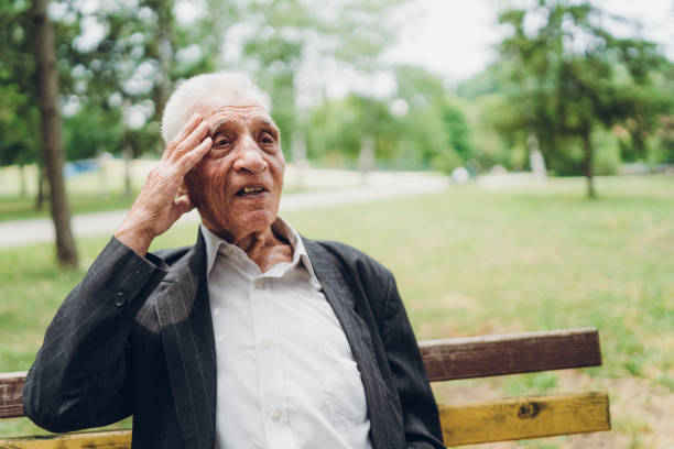 istock Sad senior man sitting on a park bench 1204164209