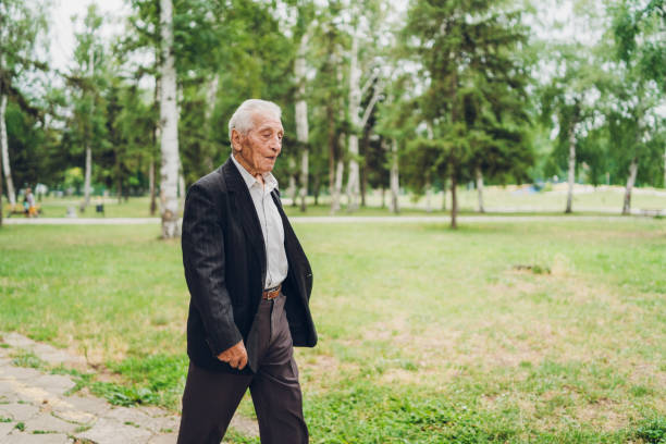 istock Senior man walking in a park 1204164340