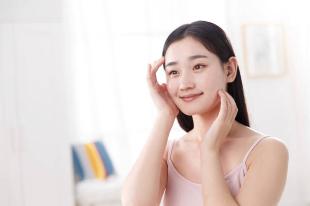 istock Young women applying body lotion 1204165125