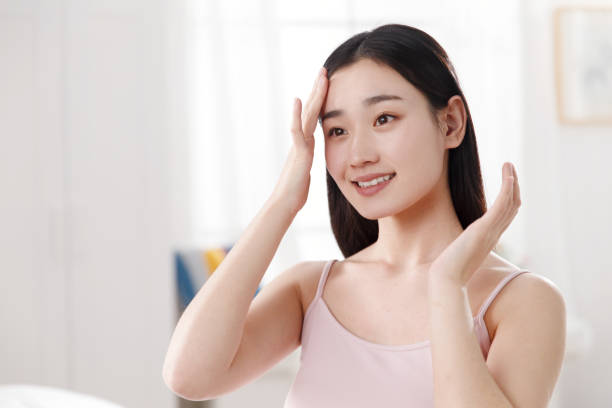 istock Young women applying body lotion 1204165308