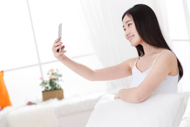 istock Young women in the bedroom self timer 1204166088