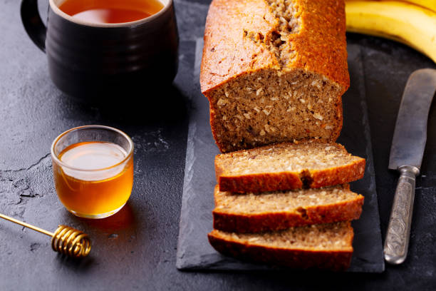 istock Banana, coconut bread, cake on slate board. Dark stone background. Close up. 1204167066