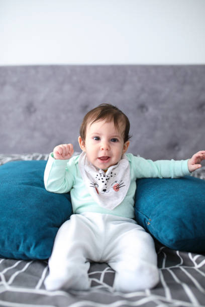 istock Newborn baby girl sitting with support pillows 1204167313