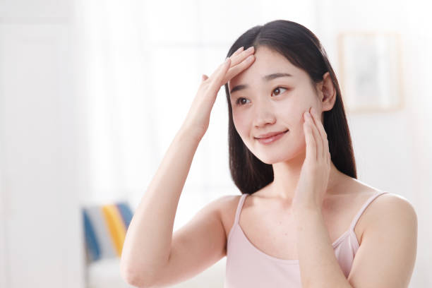 istock Young women applying body lotion 1204167687