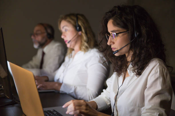 istock Team of teleworkers working in dark office 1204170584