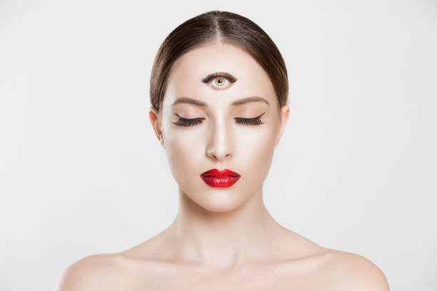 Psychic. Woman with 3 third eye looking at you camera concentrating thinking with mind and heart intuition about problem isolated white grey background. Making smart decision find solution concept stock photo