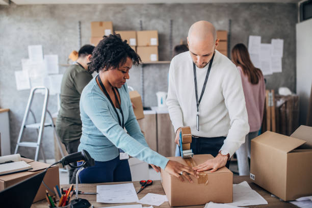 istock Diverse group of people arranging customers orders for drop shipping 1204171601