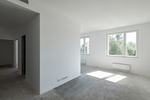 New apartment without decoration, sunny view outside the window, white walls