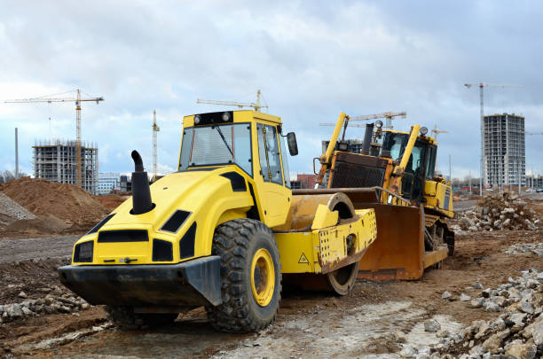 istock Soil Compactor and bulldozer at construction site. Vibration single-cylinder road roller 1204174795