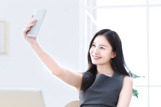 istock Business women use mobile phone self timer 1204174948