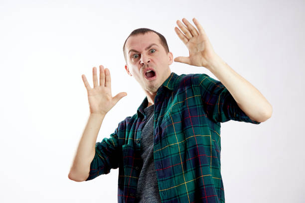 istock Fear and fright of a man. Guy is afraid, scared face 1204175991