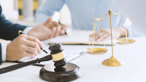 istock lawyer consulting with client discussing about contract. 1204176256