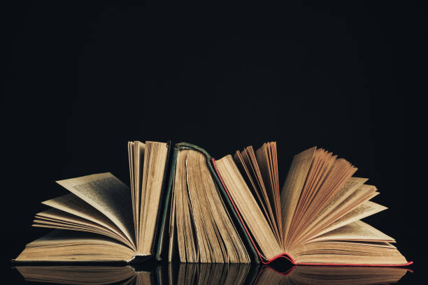 istock Beautiful ancient books. Pattern background for design. The book on a black glass table  background. 1204176711