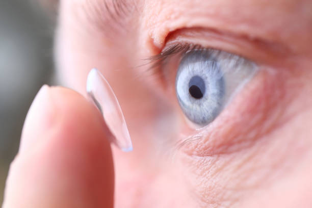 istock Man putting on soft contact lens 1204177546