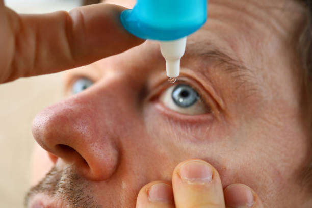 istock Male hand putting liquid drops in his eye 1204177556