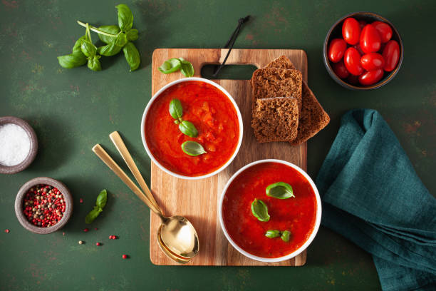istock tomato and bell pepper vegetarian soup on green background 1204177912