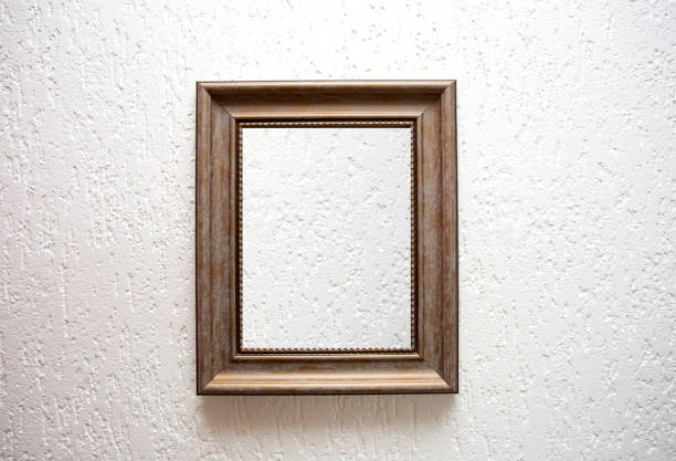 istock One empty wooden frame on a white wall background texture, retro modern design 1204179033