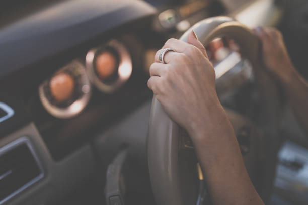 istock Pretty, young woman  driving a car 1204179554