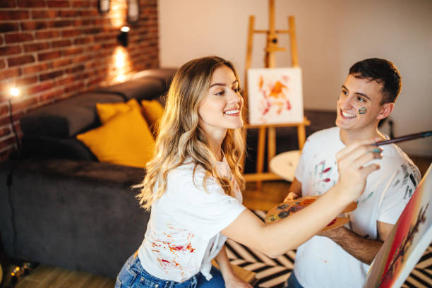 istock Lovely couple painting on canvas 1204179802
