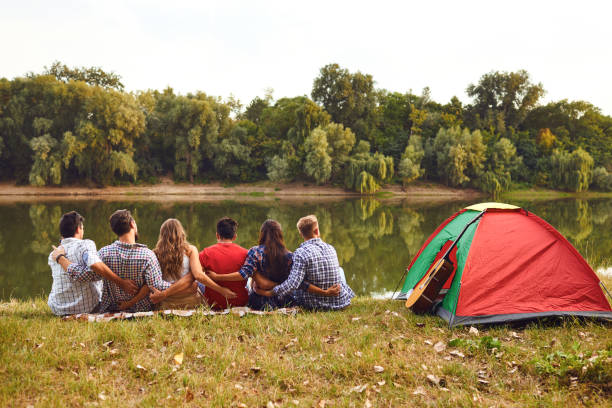istock Group of people smiling standing on a picnic 1204179868
