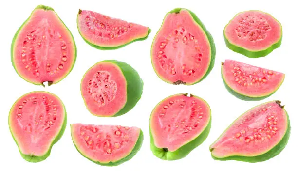 Isolated guava pieces. Collection of cut green pink fleshed guava fruits of different shapes isolated on white background with clipping path