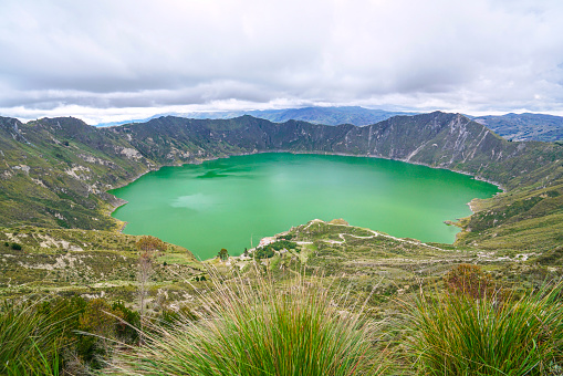 Quilotoa volcano lake is 3ooo m wide, about 250 deep and on the Elevation 3,914 m. The greenish color coms from dissolved minerals and it is touristic destination with hiking down to the lake.