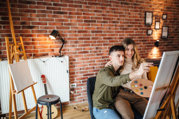 istock Couple having fun at home, painting on canvas 1204183152