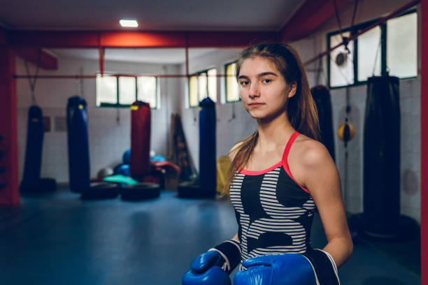 Young beautiful teenage girl boxing in the gym.
