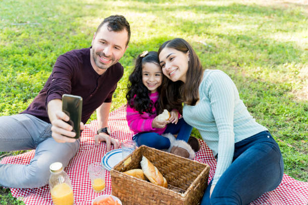 istock Father Taking Selfie With Family At Park 1204185007