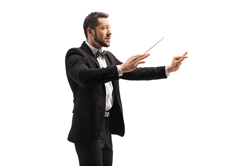 Male conductor in a suit conducting with a baton and gesturing with hand isolated on white background