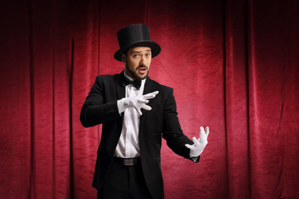 istock Male magician performing a trick with haon a stage 1204186035