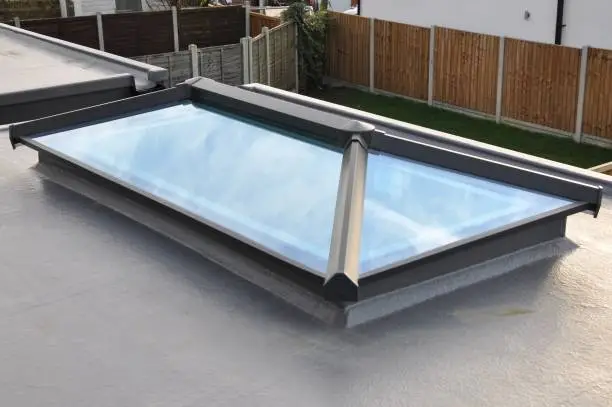 Glass roof lantern in a flat roof of a new build house. Elevated view, with reflected sky. Billericay, Essex, United Kingdom, January 29, 2020