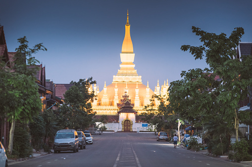 Vientiane, Laos - April  28 2019: Outside of That Luang (also known as the Golden Stupa), a gold-covered large Buddhist stupa in the centre of Vientiane, Laos.