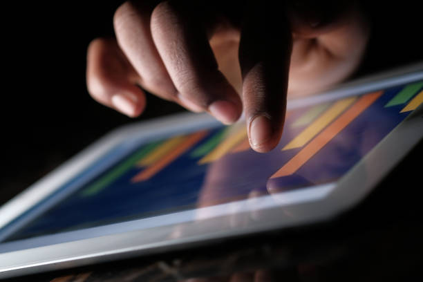 istock close up of man hand analyzing chart on  digital tablet 1204186433