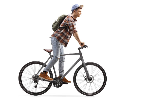 istock Male student standing and riding a bicycle 1204186988