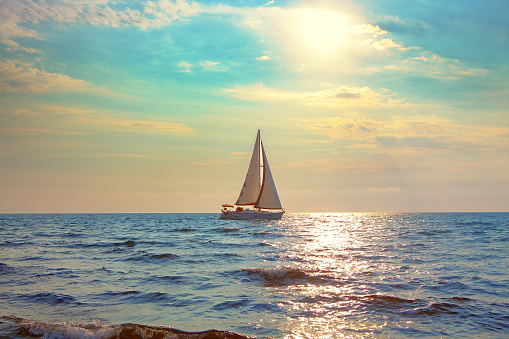 white yacht sailing in the sunlight