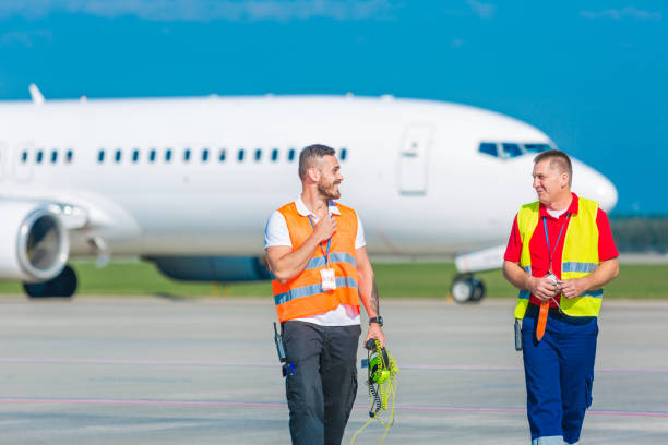 istock Airport ground crew walking on the runway 1204187970