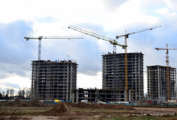 istock Tower cranes constructing a new residential building at a construction site 1204188468