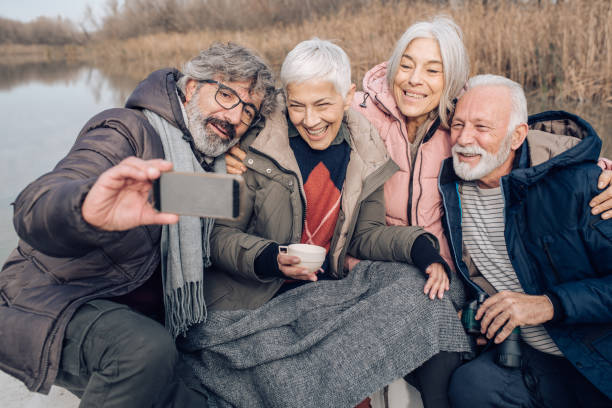 istock Happy seniors sailing the river and taking a selfie 1204189043