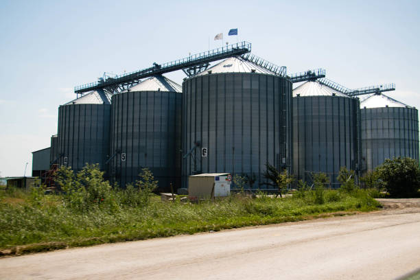 istock Grain Silo Bins in Farm Field Agricultural Landscape 1204189330