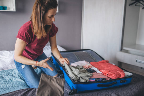 istock One woman packing suitcase for vacation 1204190907