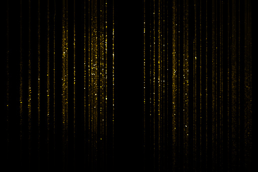 Gold glittering threads on black background
